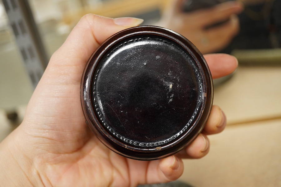 A Chinese silvered bronze mirror, a lacquer box and a jade cylindrical bead, largest 15cm diameter. Condition - fair to good